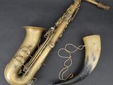an old saxophone with a horn on a black background