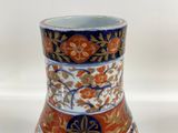 a vase that is sitting on a white surface