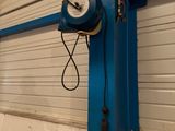 un poteau bleu sur lequel est fixée une horloge, dans un garage