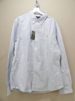 the shirt is hanging on a hanger on the wall