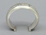 an antique silver cuff bracelet with a design on the side