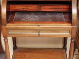 a wooden desk with a glass top and drawers