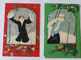four christmas cards that are on display on the wall
