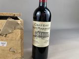 a bottle of wine sitting next to a box of wine