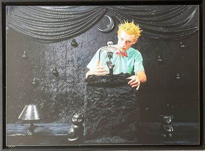 framed photograph of a man with yellow hair holding a glass