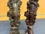 pair of bronze statues of a woman and a man on a pedestal
