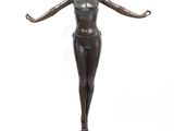 bronze statue of a woman standing on a pedestal with her arms outstretched