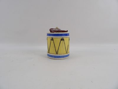a small yellow and blue drum on a white surface