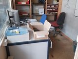 a room with a desk, a chair, and a window