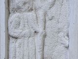 a stone carving of a man holding a sword