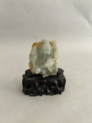 an image of a statue of a person sitting on a rock