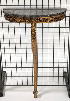 a close up of a table with a marble top and metal legs