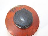 a rusted metal cap on top of a rusted stove