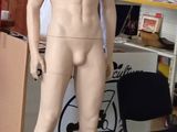 a mannequin of a man standing in a garage