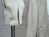 pair of white vests and pants on a mannequin stand