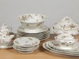 a lot of plates and bowls that are on a table