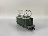 a green train on a white surface with a white background