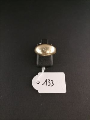 a close up of a bell on a black surface with a price tag