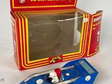 a blue toy car in front of a red box