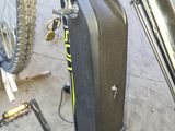 a bike with a suitcase attached to the back of it