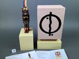 a small statue of a man on a pedestal next to a card