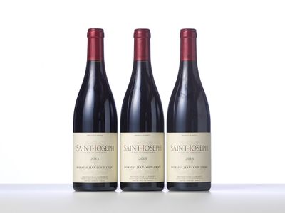 three bottles of wine sitting on top of a table