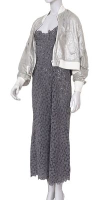 the mannequin is wearing a silver dress and a silver jacket