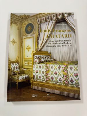 a book with a picture of a bed in a room