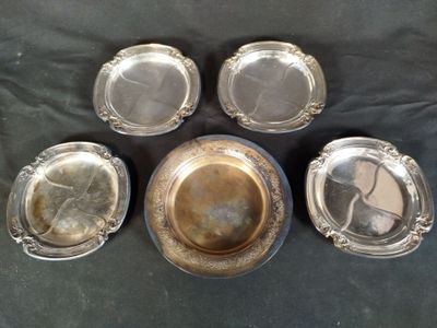 six silver plated dishes on a table with a black background