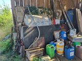 a pile of junk in a yard with a fence in the background