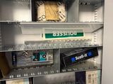 many boxes of electronic equipment on the shelves in the store