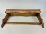 an old wooden shelf with a wooden handle on it