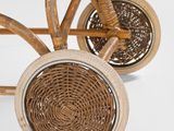 a wicker stroller with a basket on the back of it