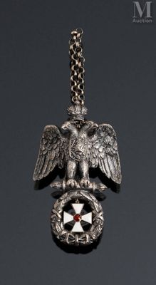 an image of a silver eagle with a cross on it ' s back