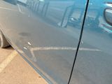 a blue car parked on the side of the street