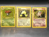 four pokemon cards are lined up in a row on a table