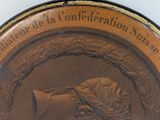 a bronze coin with a picture of a woman on it