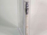 a clear box with a pen in it on a white surface