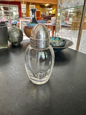 a glass salt and pepper shaker sitting on a table