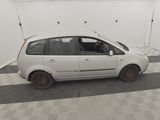 a small white car that is parked in a garage