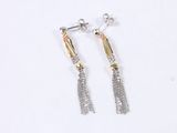 two tone gold and silver tassel earrings on a white background