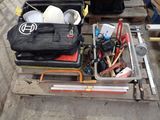 many tools sitting on a pallet on the ground