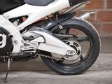 a motorcycle parked in front of a brick wall