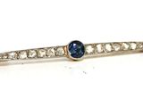 un gros plan sur une broche en forme de losange bleue et blanche