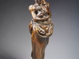 bronze statue of a woman carrying a child on her back
