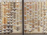 many different kinds of beads on display in a display case