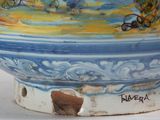 a blue and white bowl with a painting on it