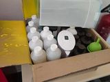 a box full of bottles of paint sitting on a table