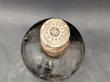 a bottle with a gold cap sitting in a sink