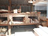 a large room with a lot of wood on the shelves